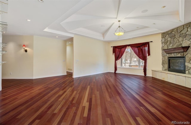 unfurnished living room with a fireplace, baseboards, wood finished floors, and recessed lighting