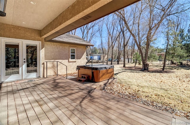 wooden deck with a hot tub