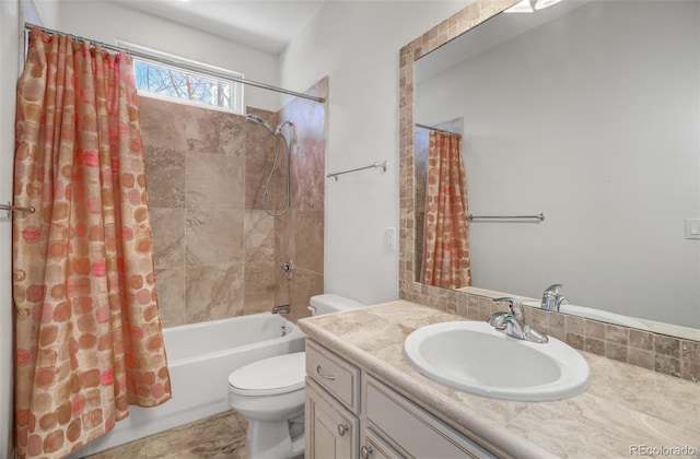 bathroom with shower / bath combo, vanity, and toilet