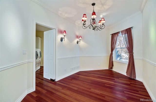 unfurnished dining area with visible vents, ornamental molding, wood finished floors, washer and dryer, and a chandelier