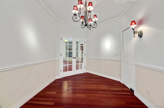 unfurnished dining area with ornamental molding, french doors, baseboards, and wood finished floors