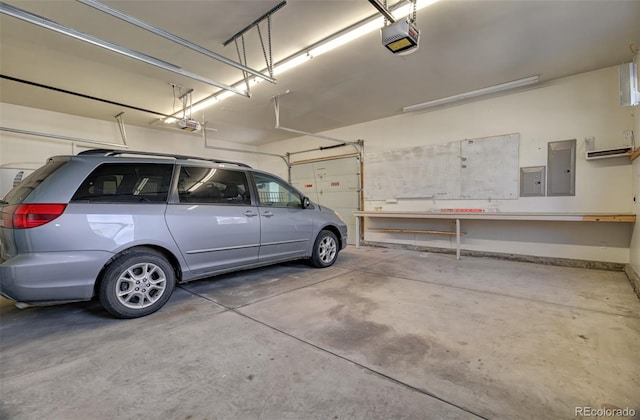 parking garage featuring electric panel, baseboards, and a garage door opener