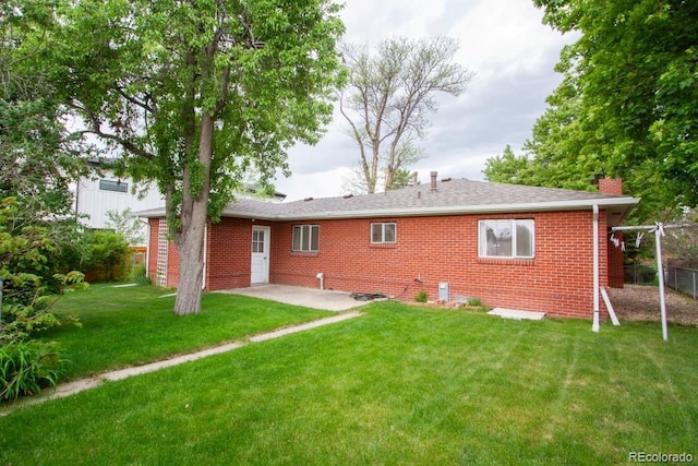 3222 Fenton St, Wheat Ridge, CO 80212 - rear view of house featuring brick siding, a patio, and a chimney
