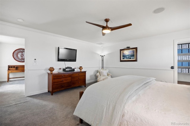 carpeted bedroom with crown molding, baseboards, ceiling fan, and visible vents