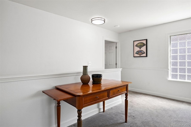 carpeted home office featuring baseboards