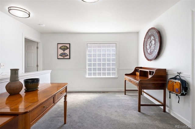 carpeted office space featuring baseboards