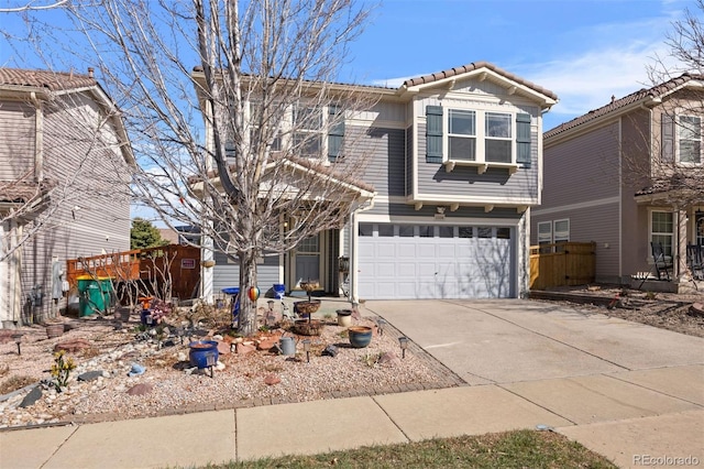 traditional home with an attached garage, driveway, and a tiled roof