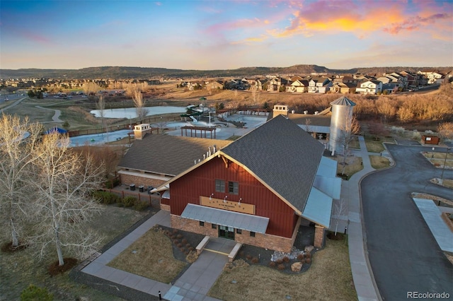 aerial view at dusk with a residential view and a mountain view