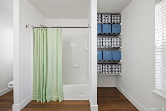 2320 Morningview Ln, Castle Rock, CO 80109 - full bathroom featuring shower / tub combo with curtain, toilet, wood finished floors, and baseboards