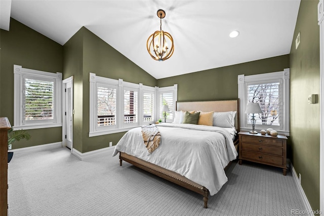 carpeted bedroom featuring a chandelier, lofted ceiling, and baseboards