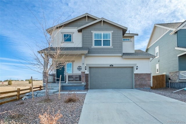 craftsman house with driveway, stone siding, a porch, fence, and an attached garage