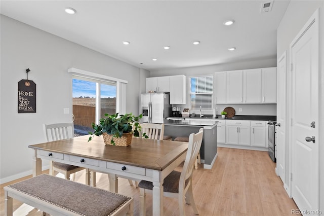 dining space with recessed lighting, visible vents, and a healthy amount of sunlight