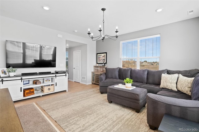 living area with recessed lighting, visible vents, light wood-style floors, and an inviting chandelier