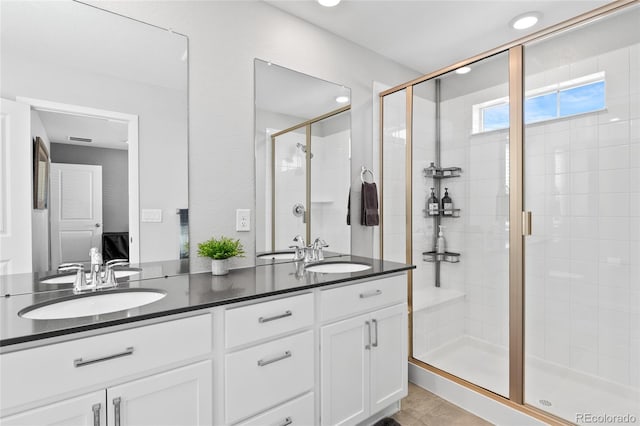 bathroom with a sink, ensuite bathroom, double vanity, and a shower stall