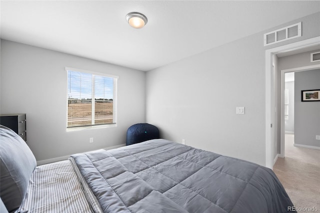 bedroom with visible vents, carpet flooring, and baseboards