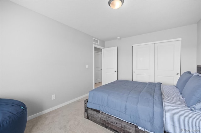 bedroom featuring a closet, baseboards, visible vents, and carpet floors