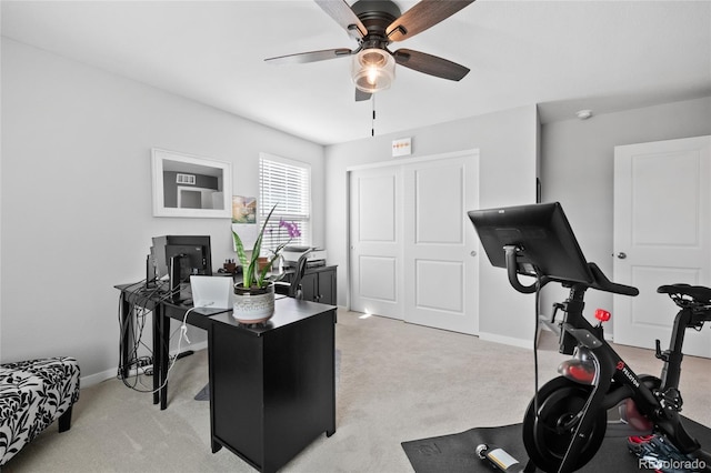 office featuring light colored carpet, baseboards, and ceiling fan