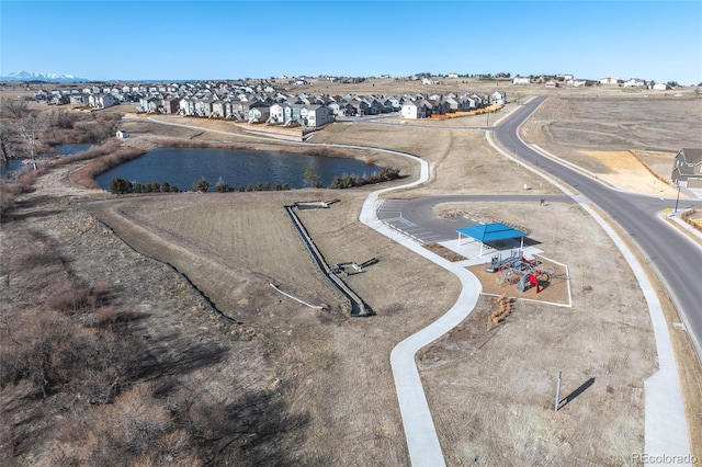 drone / aerial view with a residential view and a water view