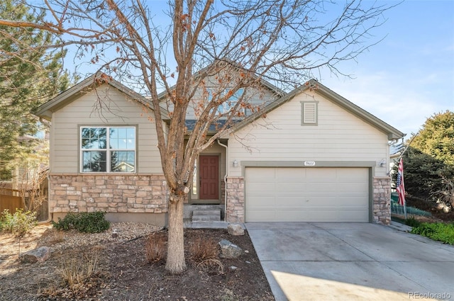 view of front facade featuring an attached garage, stone siding, and concrete driveway