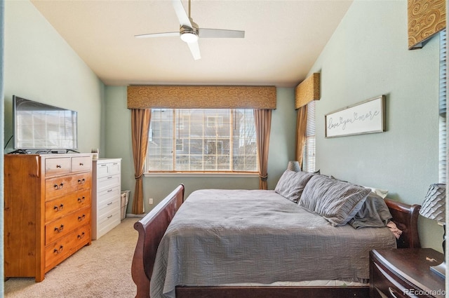 bedroom featuring a ceiling fan and light colored carpet