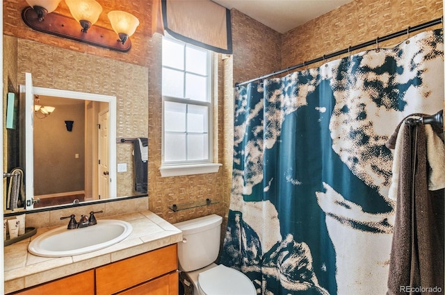 full bathroom featuring toilet, wallpapered walls, a shower with curtain, and vanity