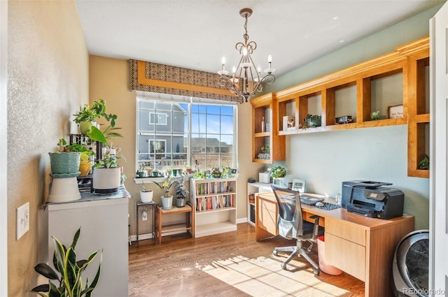 office featuring a chandelier, baseboards, and wood finished floors