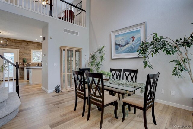 9079 Garnet St, Highlands Ranch, CO 80126 - dining space with light wood-type flooring, baseboards, and a high ceiling