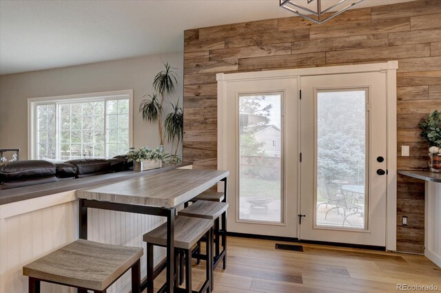 9079 Garnet St, Highlands Ranch, CO 80126 - dining area featuring light wood-style flooring and wooden walls