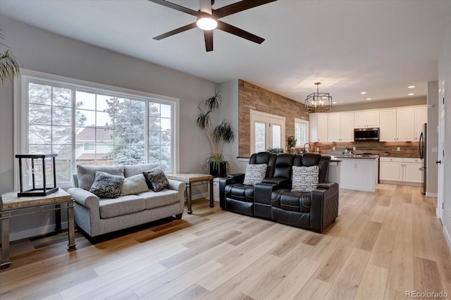 9079 Garnet St, Highlands Ranch, CO 80126 - living room featuring ceiling fan, a chandelier, healthy amount of natural light, light wood-style floors, and recessed lighting