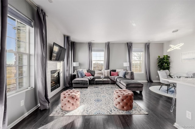 living room featuring dark wood-type flooring and a notable chandelier