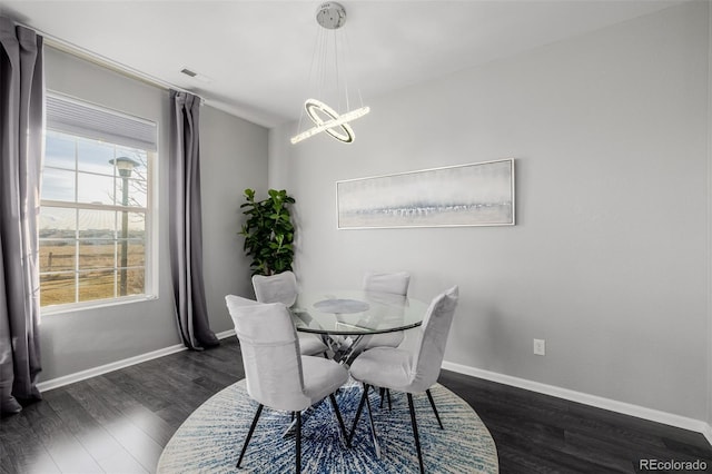 dining area featuring a chandelier and dark hardwood / wood-style floors