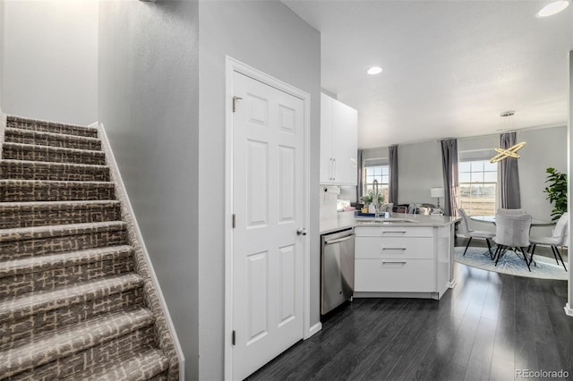 staircase featuring hardwood / wood-style floors and a notable chandelier