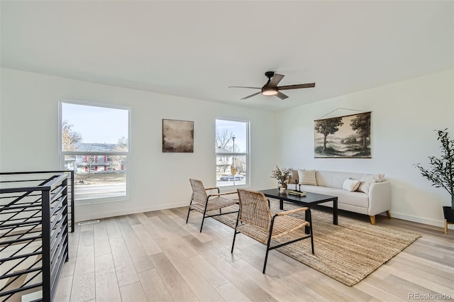 living room with ceiling fan and light hardwood / wood-style floors