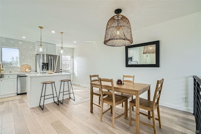 dining space featuring a chandelier and light hardwood / wood-style floors