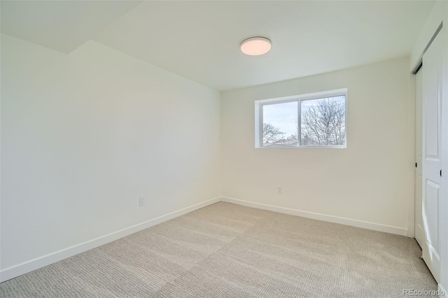 unfurnished room with light carpet