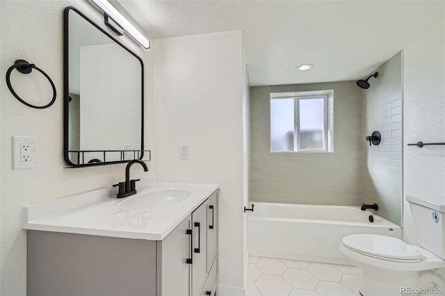 full bathroom featuring vanity, tile patterned flooring, tiled shower / bath combo, and toilet