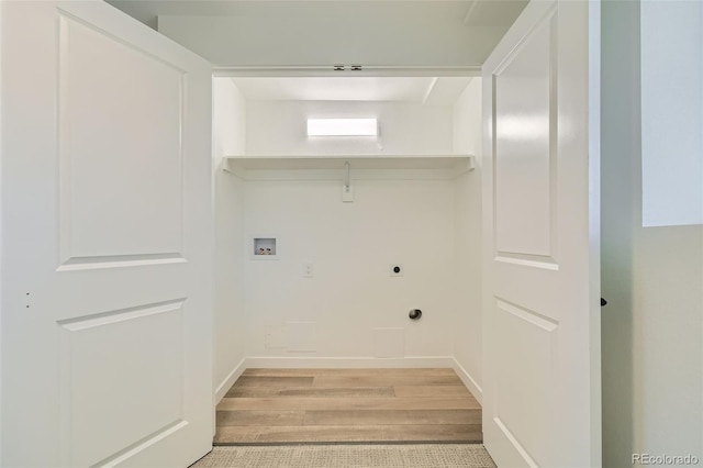 clothes washing area featuring washer hookup, light hardwood / wood-style floors, and hookup for an electric dryer