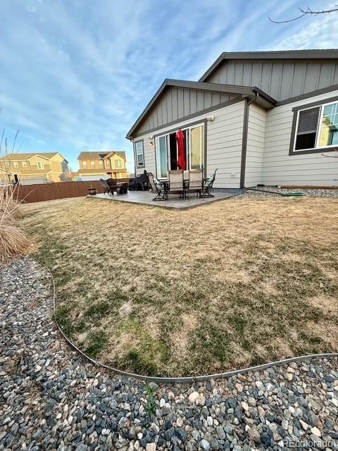 back of property featuring a patio area, fence, and board and batten siding