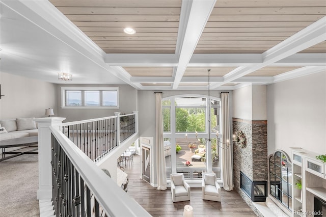 corridor featuring coffered ceiling, beamed ceiling, and hardwood / wood-style floors