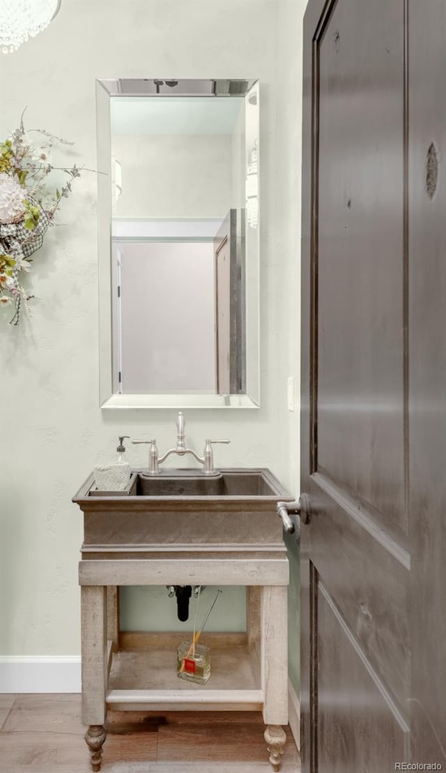 bathroom with hardwood / wood-style floors