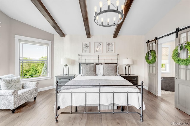 bedroom featuring light hardwood / wood-style flooring, a notable chandelier, beam ceiling, and a barn door