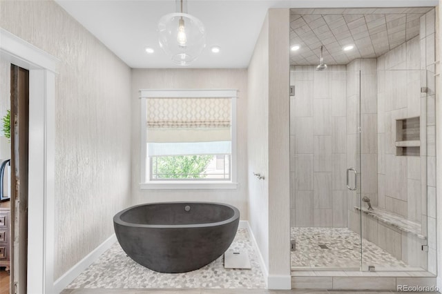 bathroom featuring shower with separate bathtub