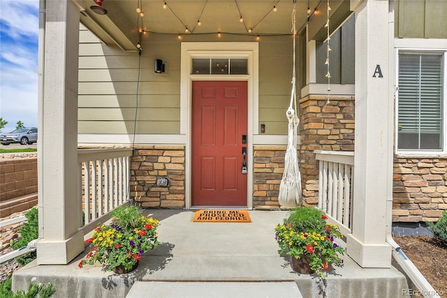 16818 E 119th Ave Unit A, Commerce City, CO 80022 - view of exterior entry with a porch and stone siding
