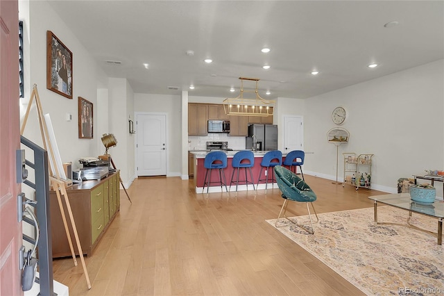 16818 E 119th Ave Unit A, Commerce City, CO 80022 - living room with recessed lighting, light wood finished floors, a chandelier, and baseboards
