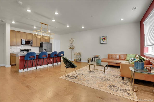 16818 E 119th Ave Unit A, Commerce City, CO 80022 - living room featuring light wood-type flooring, recessed lighting, and baseboards