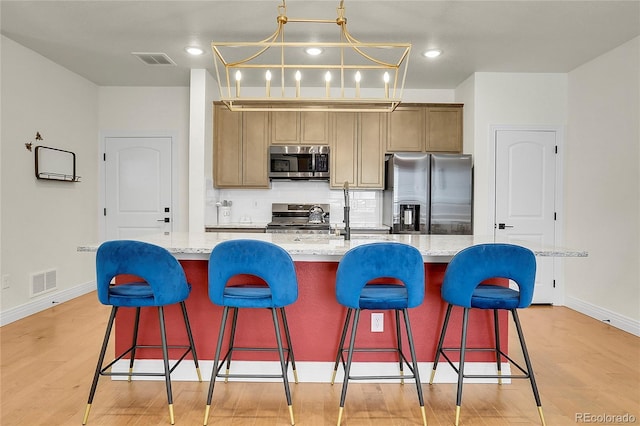 16818 E 119th Ave Unit A, Commerce City, CO 80022 - kitchen featuring stainless steel appliances, baseboards, light wood finished floors, and recessed lighting