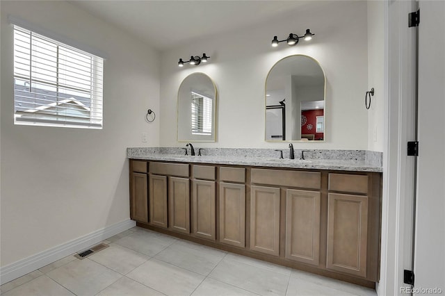 16818 E 119th Ave Unit A, Commerce City, CO 80022 - bathroom with tile patterned floors, baseboards, and double vanity