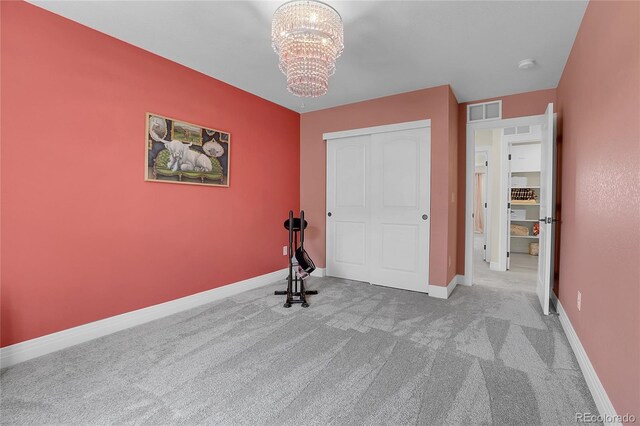 16818 E 119th Ave Unit A, Commerce City, CO 80022 - unfurnished bedroom featuring carpet floors, a chandelier, baseboards, and a closet