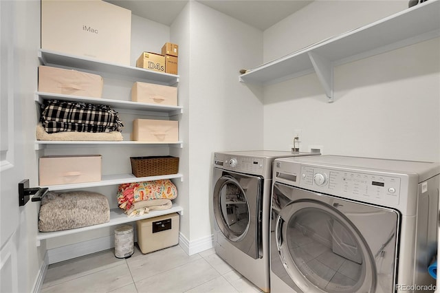 16818 E 119th Ave Unit A, Commerce City, CO 80022 - laundry room featuring separate washer and dryer, light tile patterned flooring, and baseboards