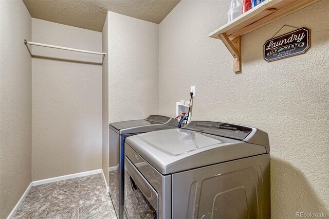 7963 Bonfire Trl, Fountain, CO 80817 - laundry room featuring washing machine and clothes dryer and a textured ceiling